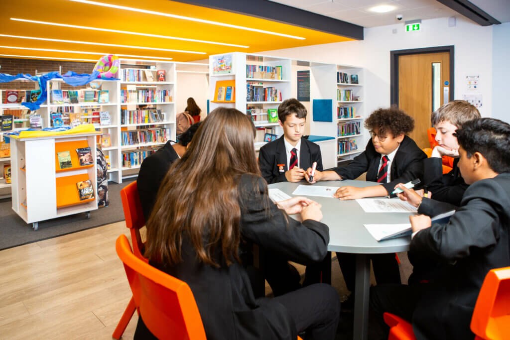 A group of children sitting around a desk