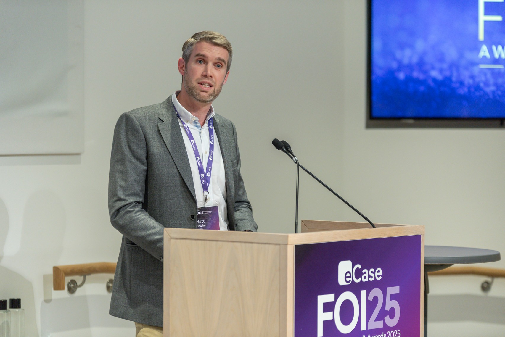 Matt Fletcher speaking at the FOI25 podium